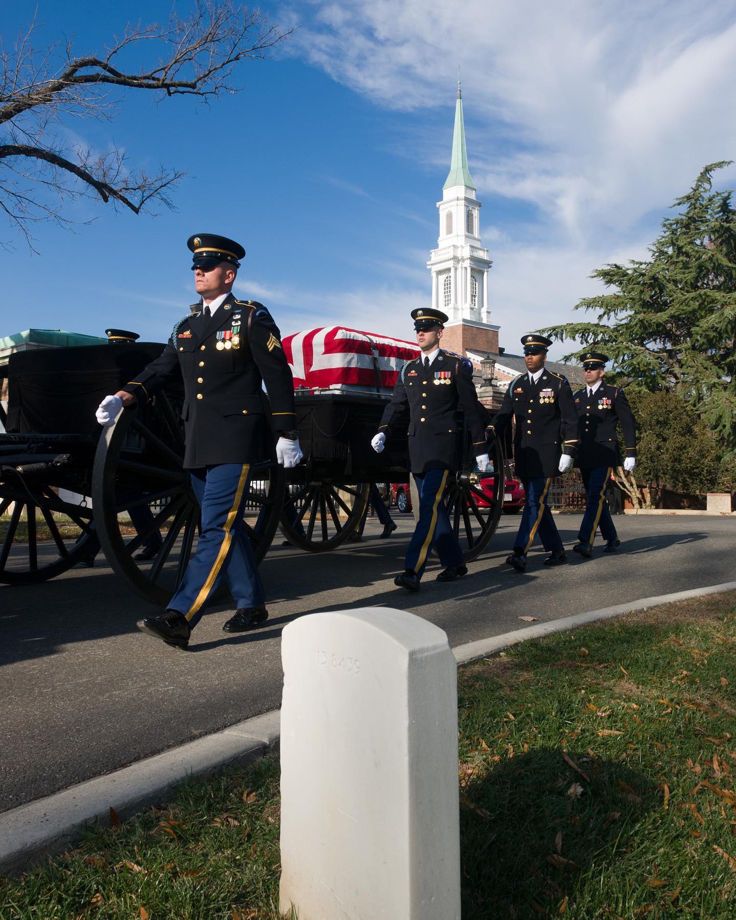 A procession leaving from the Old Post Chapel passes through Section 13 of Arlington National Cemetery in Arlington, Virginia.
