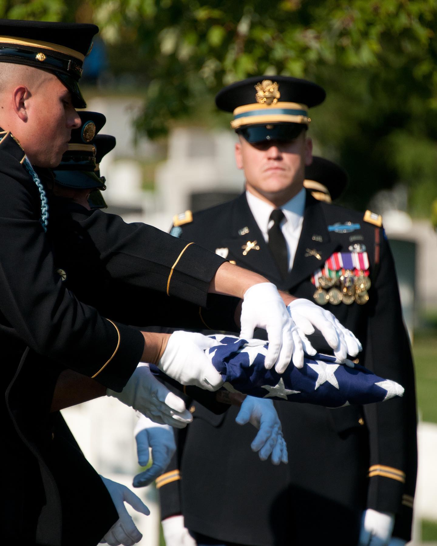 Soldiers in the 3d US Infantry Regiment, The Old Guard hold a perfectly folded flag over the casket of a soldier laid to rest in Arlington National Cemetery.

It is the solemn duty and distinct privilege of The Old Guard to render final honors for Service Members as they are laid to rest in Arlington National Cemetery.