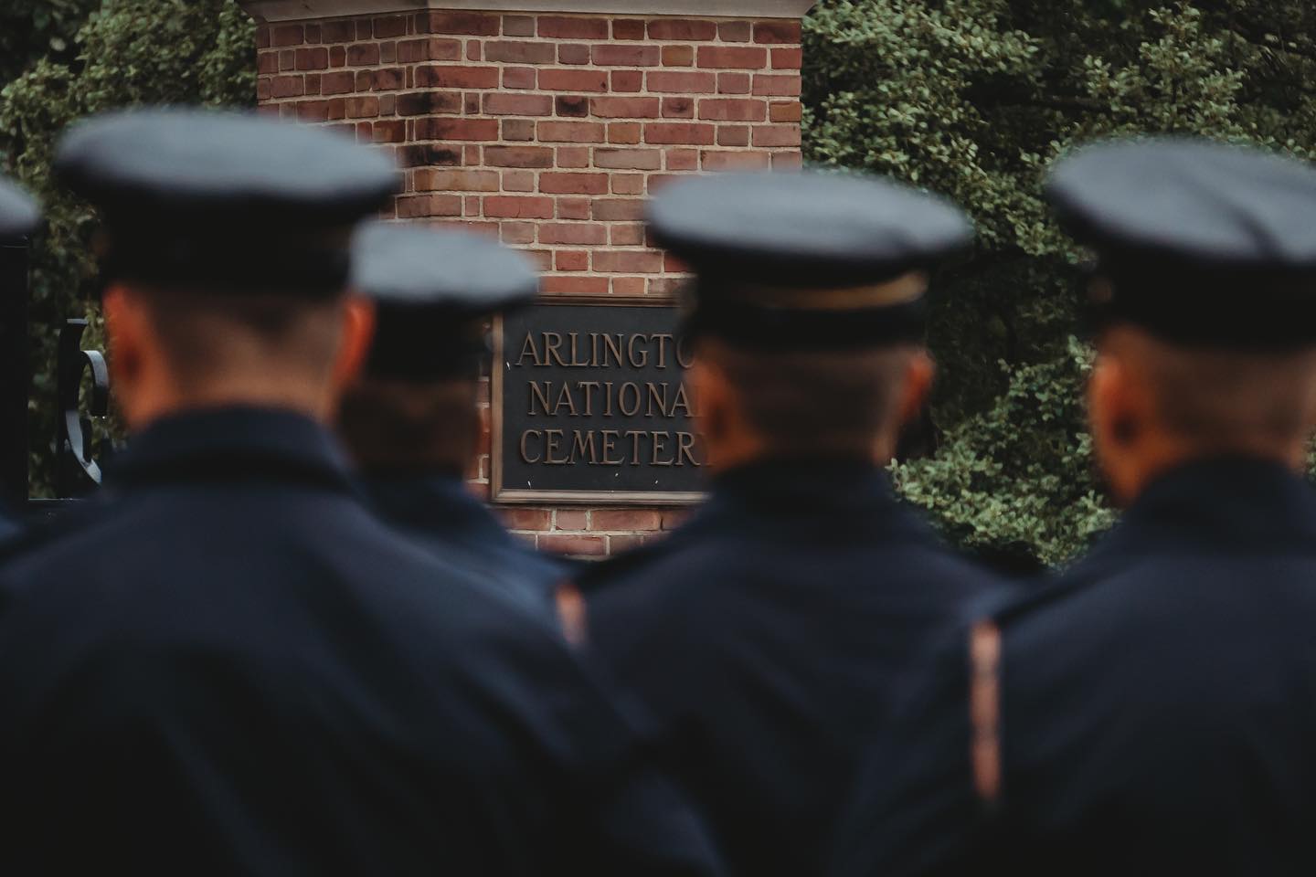 The entrance into Arlington National Cemetery's hallowed grounds can be seen in between these soldiers, poised to honor a true hero on one final mission.