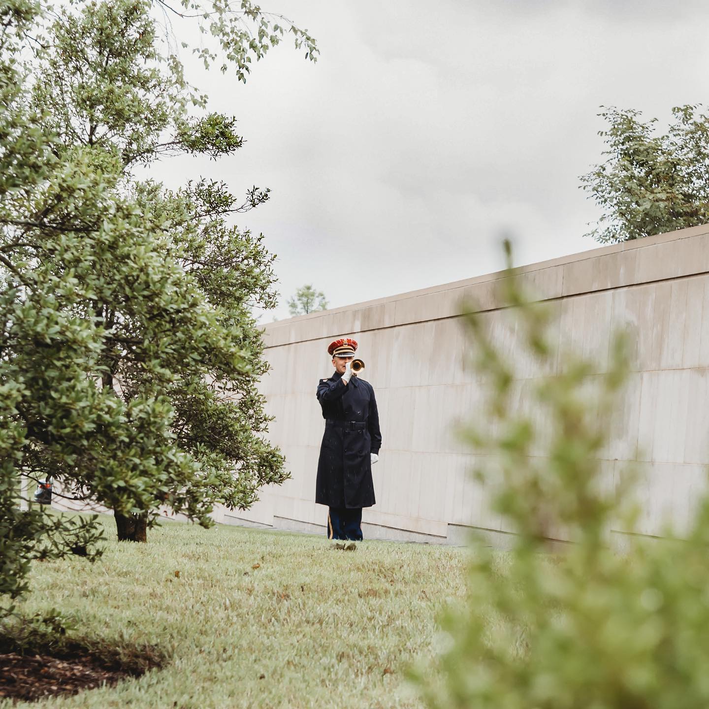 A lone bugler plays Taps outside of the Columbarium at Arlington National Cemetery on a cold morning.