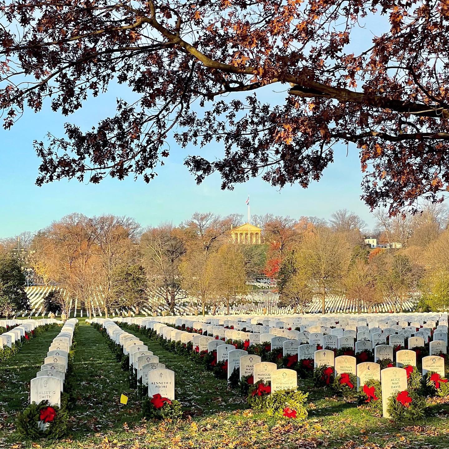 Today Arlington National Cemetery celebrated National Wreath Day. Despite the current visitor restrictions, soldiers ensured that not a single grave at Arlington National Cemetery was without a wreath. Over the past week, before the grounds opened, soldiers laid wreaths on every grave at the cemetery, in the tradition of Morrill Worcester, so many years before. 

According to Wreaths Across America’s website: “Morrill Worcester, owner of Worcester Wreath Company of Harrington, Maine, was a 12 year old paper boy for the Bangor Daily News when he won a trip to Washington D.C. His first trip to our nation’s capital was one he would never forget, and Arlington National Cemetery made an especially indelible impression on him. This experience followed him throughout his life and successful career, reminding him that his good fortune was due, in large part, to the values of this nation and the veterans who made the ultimate sacrifice for their country.

“In 1992, Worcester Wreath found themselves with a surplus of wreaths nearing the end of the holiday season. Remembering his boyhood experience at Arlington, Worcester realized he had an opportunity to honor our country’s veterans. With the aid of Maine Senator Olympia Snowe, arrangements were made for the wreaths to be placed at Arlington in one of the older sections of the cemetery that had been receiving fewer visitors with each passing year.”

As this tradition grew over 15 years, word spread. Wreaths Across America was formed in 2007 as a non-profit organization, allowing those interested to contribute not just time but money. According to Wreaths Across America’s website: “In 2014, Wreaths Across America and its national network of volunteers laid over 700,000 memorial wreaths at 1,000 locations in the United States and beyond, including ceremonies at the Pearl Harbor Memorial, as well as Bunker Hill, Valley Forge and the sites of the September 11 tragedies. This was accomplished with help from 2,047 sponsorship groups, corporate contributions, and donations of trucking, shipping, and thousands of helping hands.”

Learn more at WreathsAcrossAmerica.org.