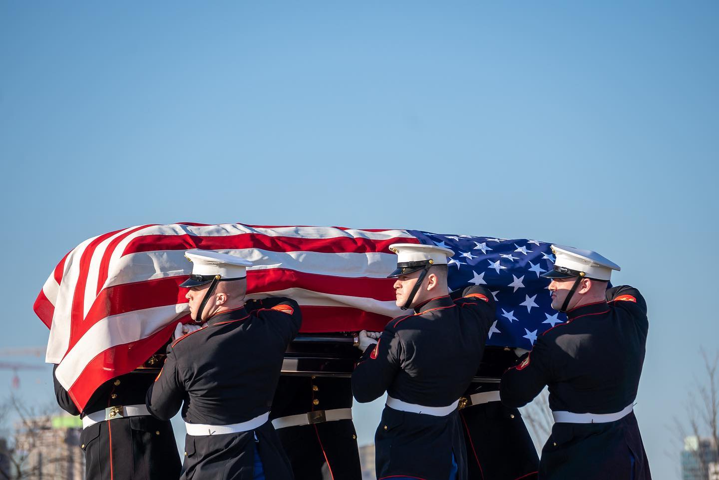 Members of the Marine Honor Guard carry a casket through section 57 of Arlington National Cemetery in Arlington, Virginia.
