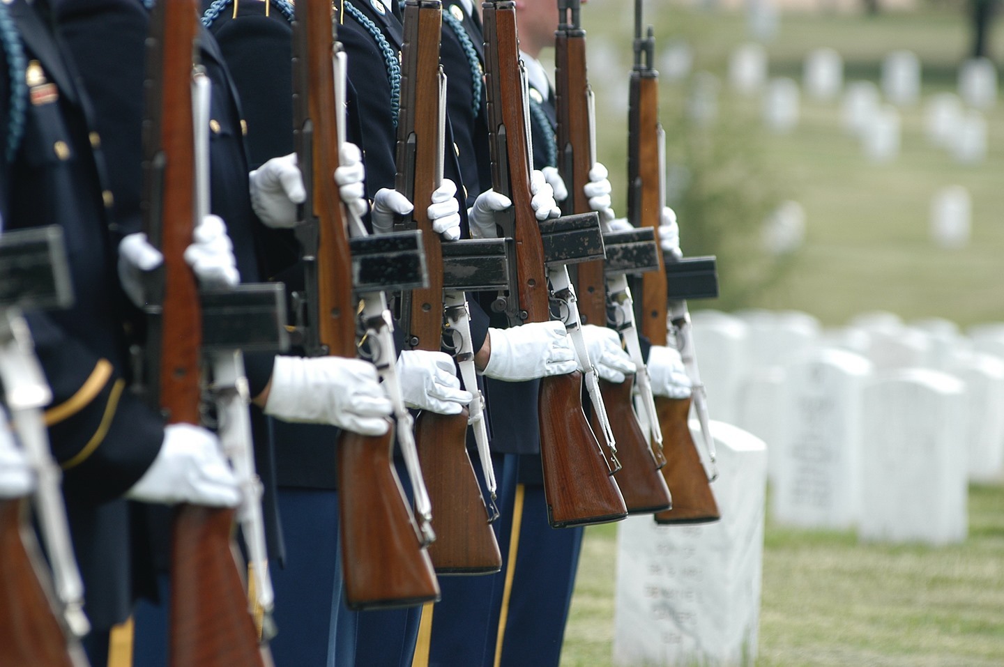 The Old Guard firing party is comprised of one firing party commander and seven Old Guard Infantryman who hold the sacred duty of rendering final honors to military veterans through the precision of a 21-gun salute. On the command of “ready” each member of the firing party removes his weapon from the safe position. 

On the command of “aim” the butt of the weapon is brought up to the pocket of the shoulder meticulously so that the handgrip rests in the palm  of the left hand, and the right hand grasps the small of the stock with the finger on the trigger. The firers then simultaneously turn their heads, keeping them vertical, to look over the barrel of the weapons. 

On the command of “fire” all weapons are fired in unison; each firer then return his weapon to the port arms position to await further orders. On the command of “ready” the firing party charges and releases the charging handle, in unison, seating the second round.
The seven members of the firing party continue to take commands from the firing party commander and execute as one element until the 21-gun salute to the honored military veteran is complete.