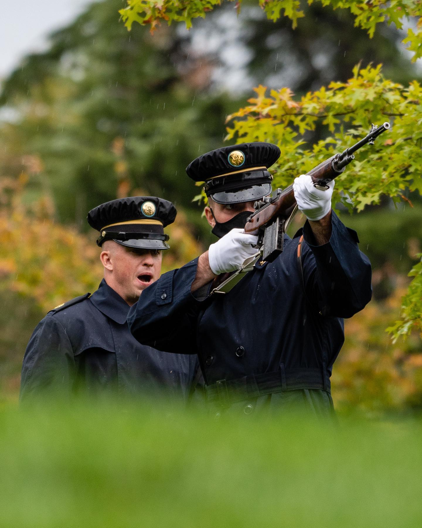 During a rainstorm, @arlingtonmedia photographers capture the firing party commander call for three successive volleys, eliciting a 21 gun salute in honor of a deceased veteran in Arlington National Cemetery.