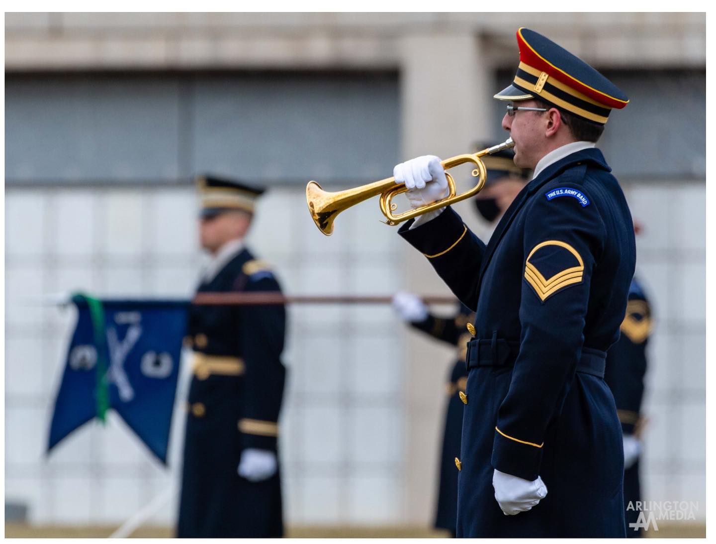 Music is an important part of a military funeral. In addition to creating a moment of contemplation at the memorial service, the ceremonial band provides a steady beat for the processional and a backdrop for the transfer of the casket and travel to the graveside.

The U.S. Army Band “Pershing’s Own” is a premier military band, and a career appointment for its musicians stationed at Fort Myer, just outside of Arlington National Cemetery. In addition to funerals, the band provides musical support for official state visits and other national events. The product must be perfect for every single mission. Each branch of the military has a premier ceremonial band to accomplish this mission for their respective funerals.

Leadership within the band are involved in the musical planning for a funeral from the beginning. They receive information from about the deceased including their religious preference or alma mater and they make musical choices based on those preferences.

“We have hundreds of hymns for all religious affiliations ready to be performed, or marches and other music for those who aren’t religious,” said Master Sgt. Rob Moore.

Moore leads the ceremonial band as the drum major, donning a large bearskin hat to make him easier to see. Music is performed by the ceremonial band whenever the casket is transported throughout the funeral service. Once the band has led the procession to the burial site, the casket team holds the flag over the gravesite waiting to be folded.

Moore said his job gives him a sense of purpose as a musician. “What we do helps to mark this moment in their [the family] lives, and nothing can do that quite like music,” he said.