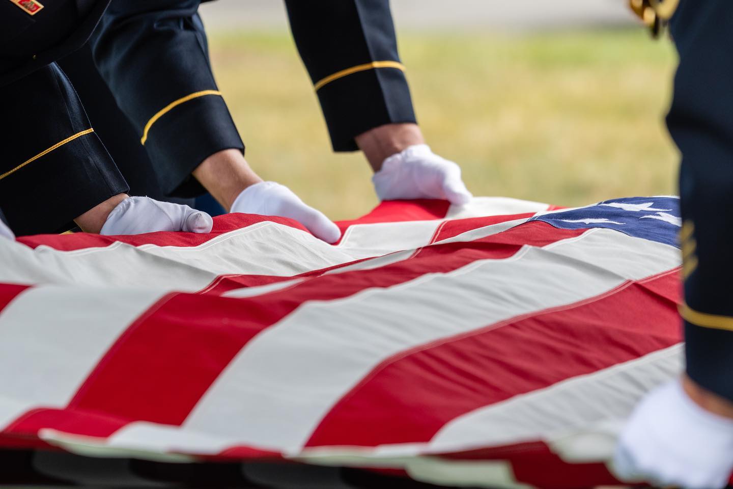The crisp white gloves of a US Army soldier fold an American flag overtop the remains of an honored veteran in Arlington National Cemetery. 

Captured by the @arlingtonmedia team.