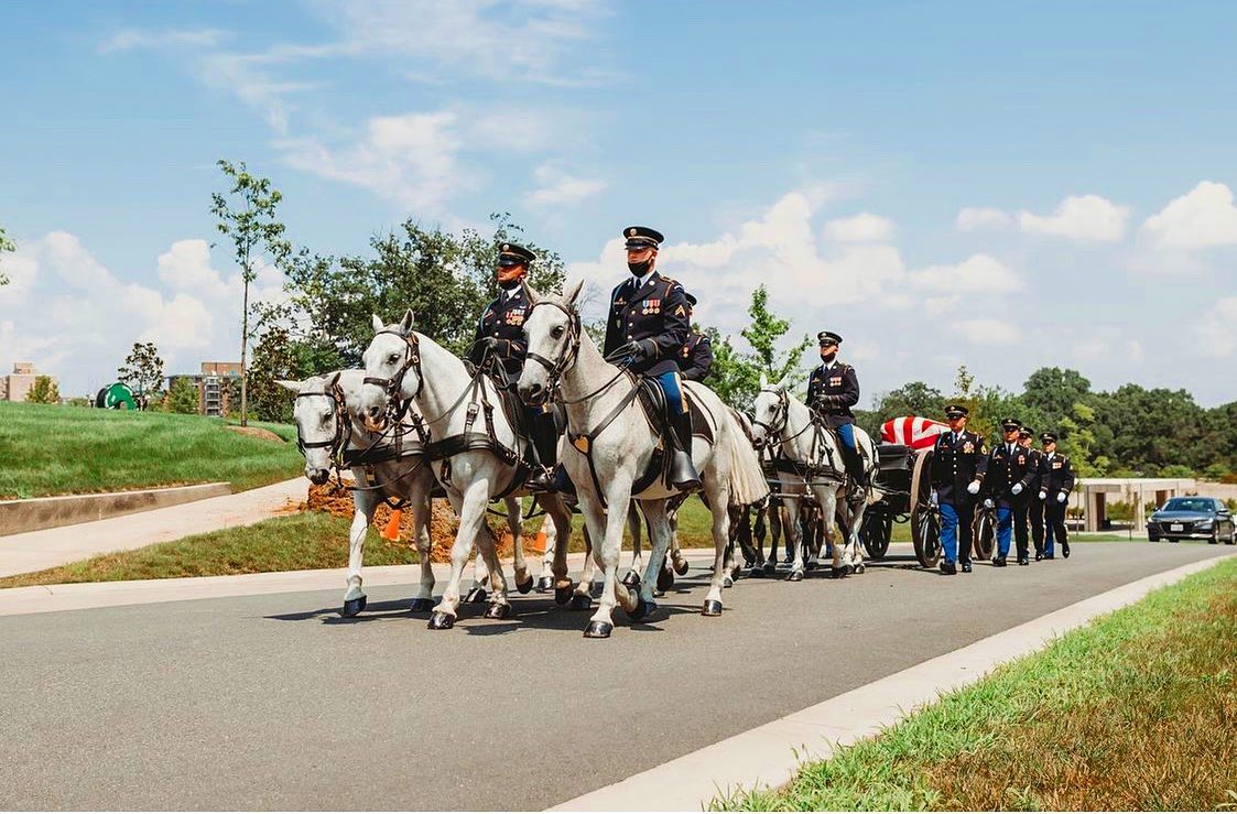 A caisson team from The Old Guard pulls a flag draped casket through the Millennium Section of Arlington National Cemetery. 

Horse-drawn caissons with large custom wooden wheels are kept in service to transport the casket. Traditionally, they were used to move artillery ammunition and cannons. The caisson is pulled by a team of specially bred and selected horses purchased or donated to the platoon. The Army’s caisson platoon provides support for military funerals for every branch of service.

The soldiers who handle the horses that pull the caisson are trained infantrymen. The Army teaches them to be expert horsemen and undergo training on a special riding style used only by the Army. The horses have to be trained to endure the sound of rifle fire, flags and crowds of people.

If you witness a funeral at Arlington, you may notice a horse without a rider among the team. This special horse is led behind the caisson and casket, wearing an empty saddle with the rider’s boots reversed in the stirrups — a symbol that the warrior will never ride again.

These are some of our favorite services to cover with our  @arlingtonmedia team