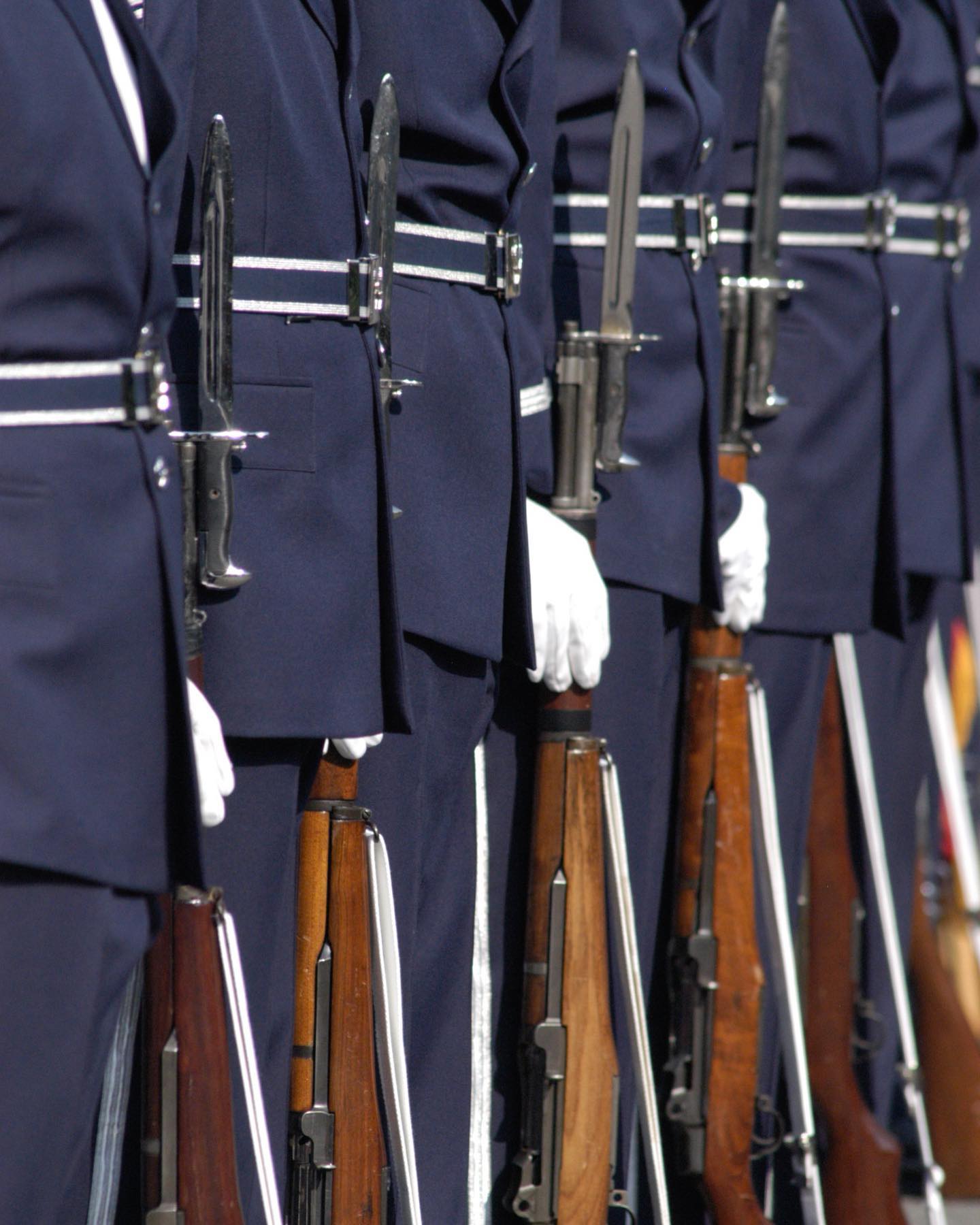 Airmen from the US Air Force firing party can be seen awaiting commands with fixed bayonets and ceremonial dress uniforms during a service in Arlington National Cemetery. 

Image captured by @arlingtonmedia