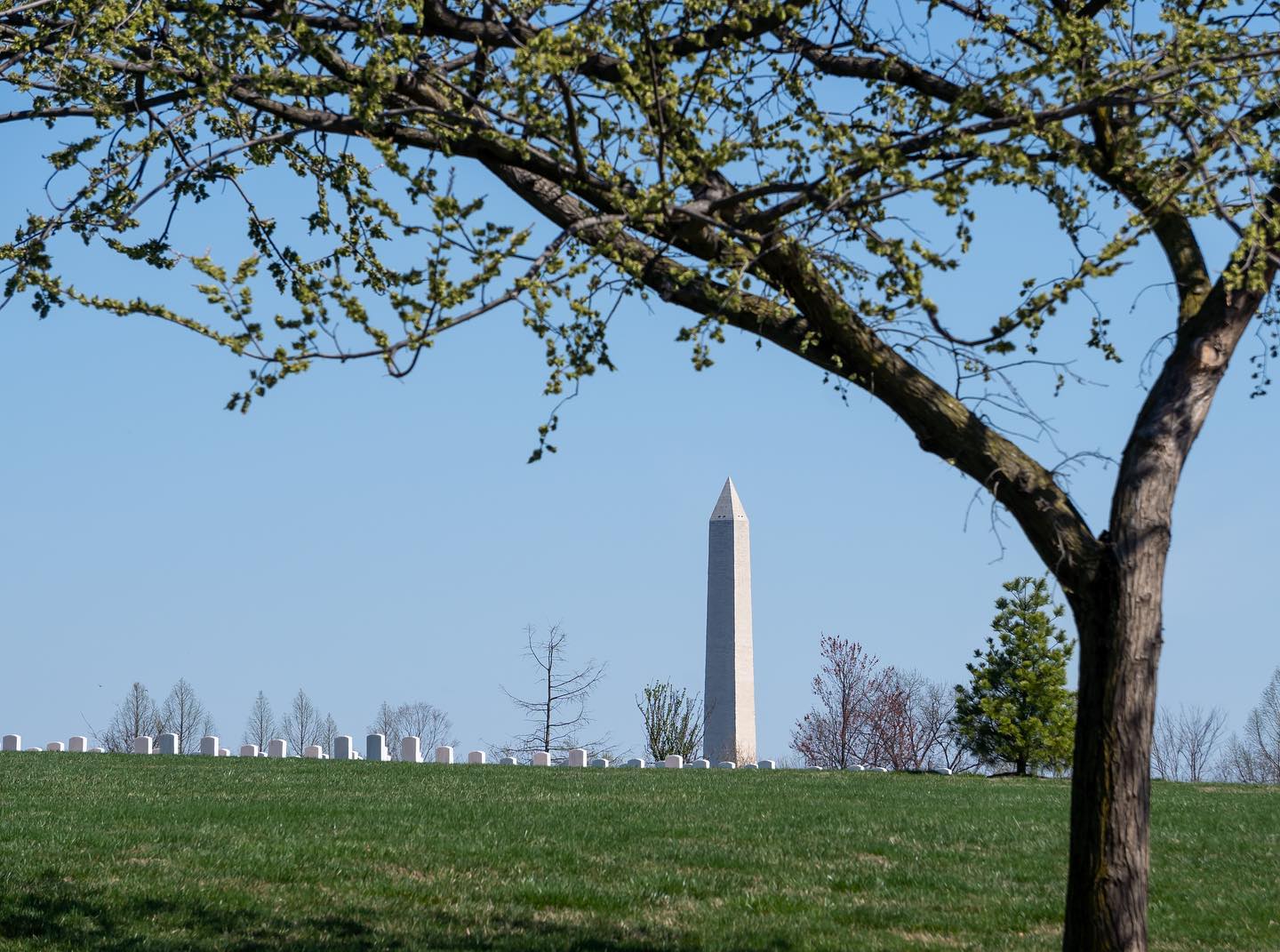 The Washington Monument appearing over McClellan Circle in Arlington National Cemetery. 

From the moment Washington D.C. was named the nation's capital, people started envisioning ways to honor America's first president. Pierre L'Enfant, the man tasked with designing what was first called ''Federal City'', created a geometric layout of streets, buildings and green spaces. One space, however, he left empty. If you draw straight lines south from the White House and west from the Capitol, that's the spot. L'Enfant left it open so a great monument to George Washington could one day be built there. Long story short: one was.

Construction began in 1848 but came to a halt from 1854 to 1877 owing to lack of funds, the Civil War, and other difficulties. By then, Mills’s design had been radically simplified for aesthetic as well as financial reasons. When construction resumed under the supervision of Col. Thomas Lincoln Casey (1831–1896) of the Army Corps of Engineers, all decorative elements and inscriptions were eliminated and the height of the monument was scaled back to just over 555 feet, 5 inches. 

Nevertheless, upon completion in 1884, the Washington Monument was the tallest built structure in the world and it remains the tallest building in Washington, DC. 

Today, it can be seen from many parts of the cemetery. A testament to our great nation and the veterans that gave their lives for it. 

PC: @arlingtonmedia