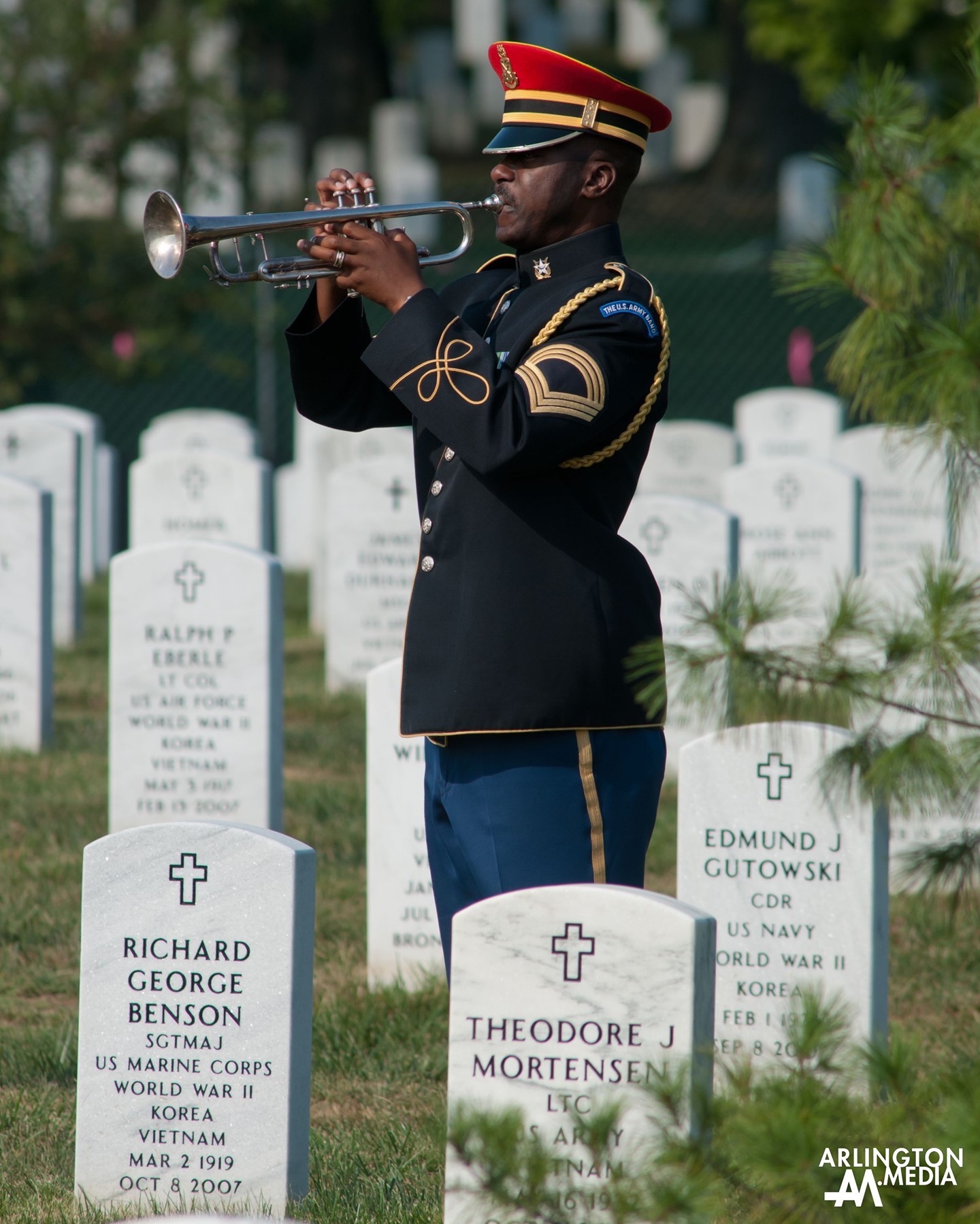 A US Army Band bugler plays Taps during military honors in Section 54 of Arlington National Cemetery.  This image was captured on a service covered by our @arlingtonmedia team.