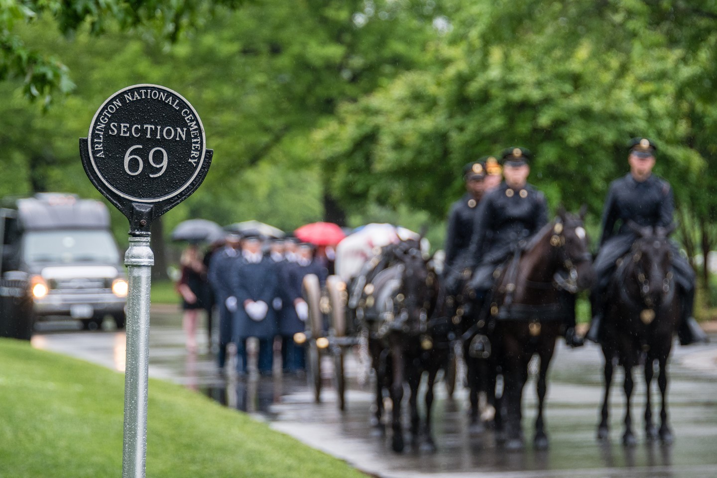 A US Army Caisson Team arrives at Section 69 of Arlington National Cemetery in a rainstorm.

Section 69 is part of the cemetery’s 1968 expansion project. This section is along the southeastern wall of the cemetery. From this section, if you look one way you will see the Air Force Memorial. Look the other, and you can see the Washington Monument through the trees and the Pentagon over the fence.