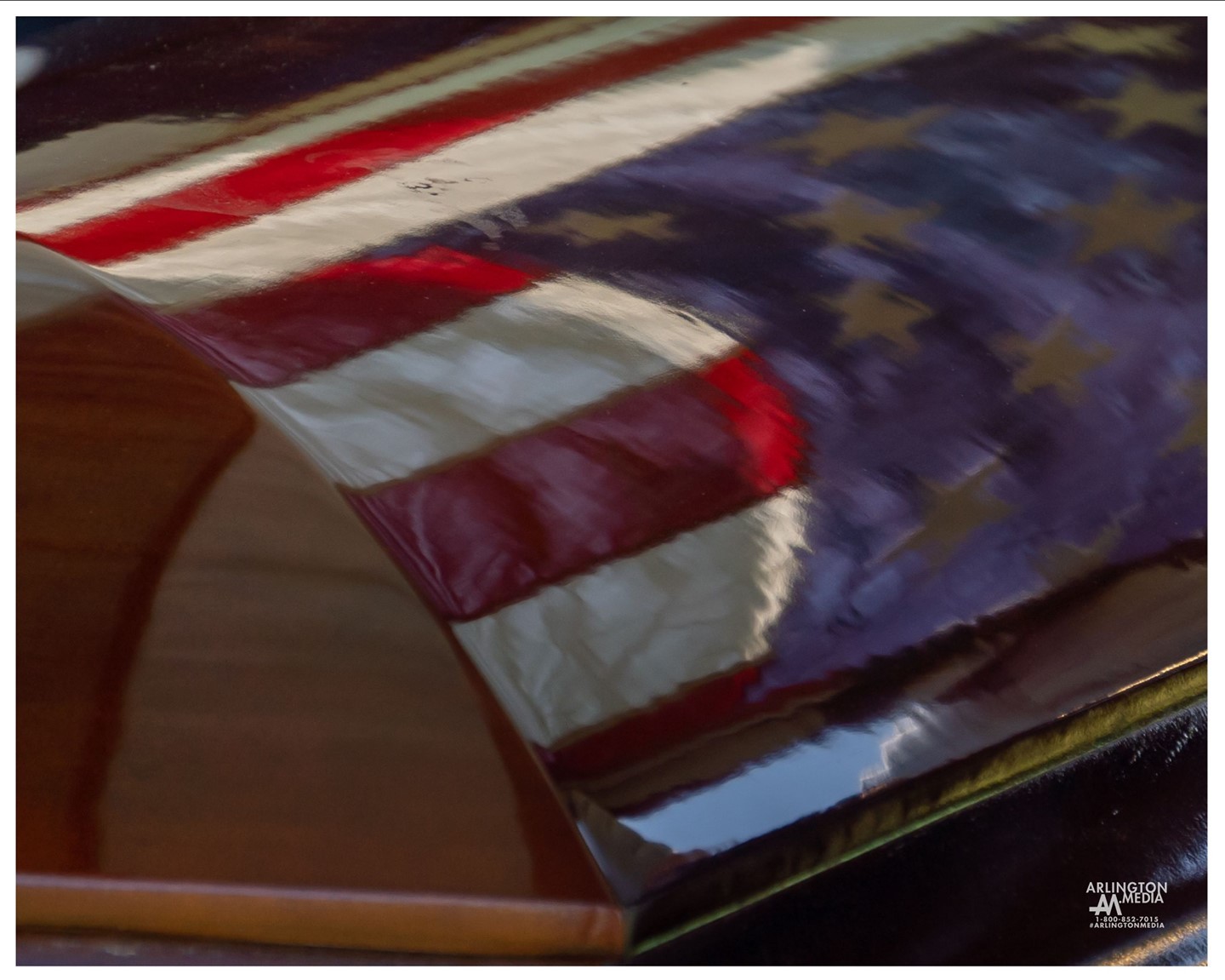 A flag is seen reflected in the casket of an honored veteran during a full honors service in Section 57 of Arlington National Cemetery.  This moment was captured by our @arlingtonmedia team.