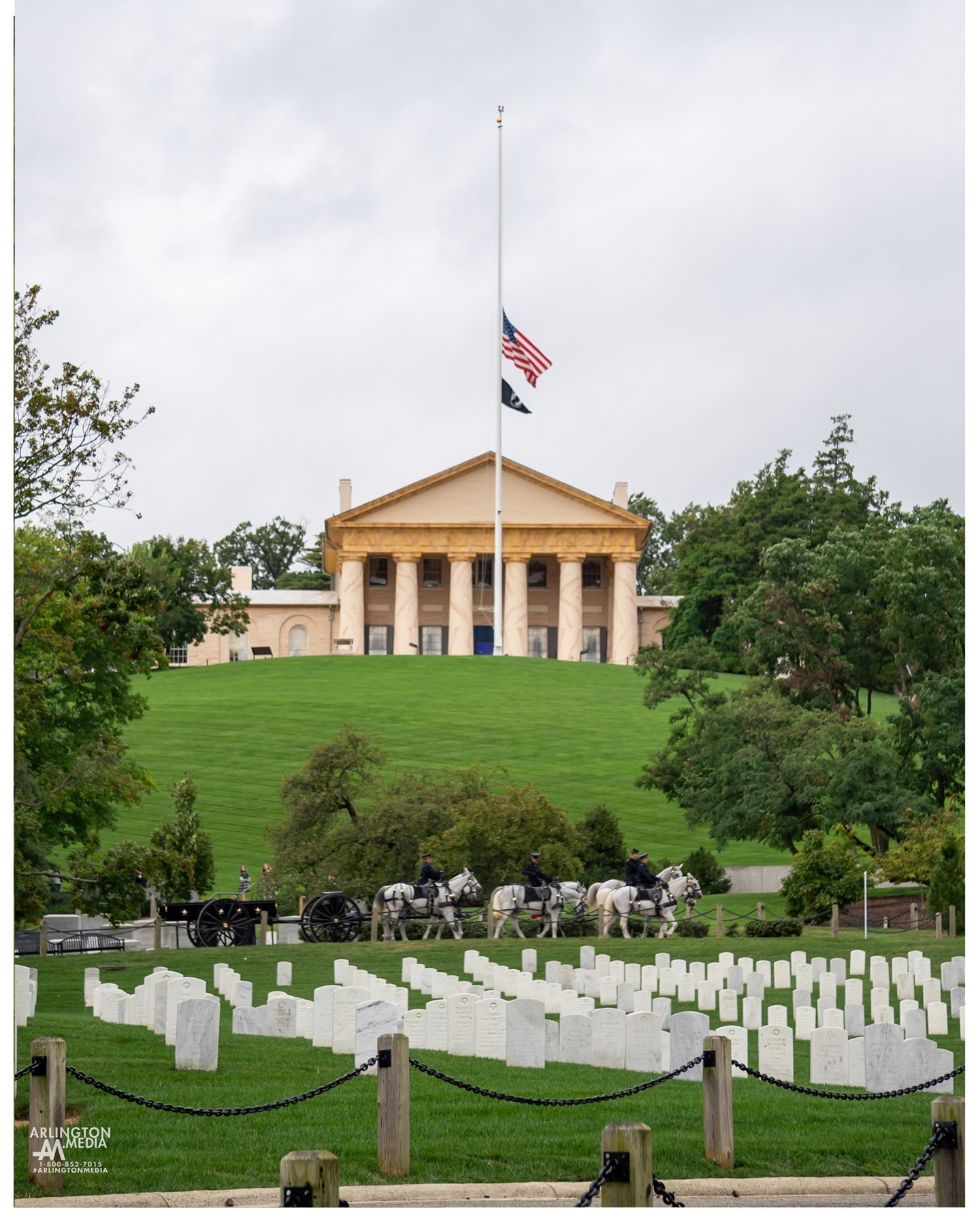 A US Army Caisson team passes in front of the Arlington House during preparation for a day of funerals in Arlington National Cemetery.