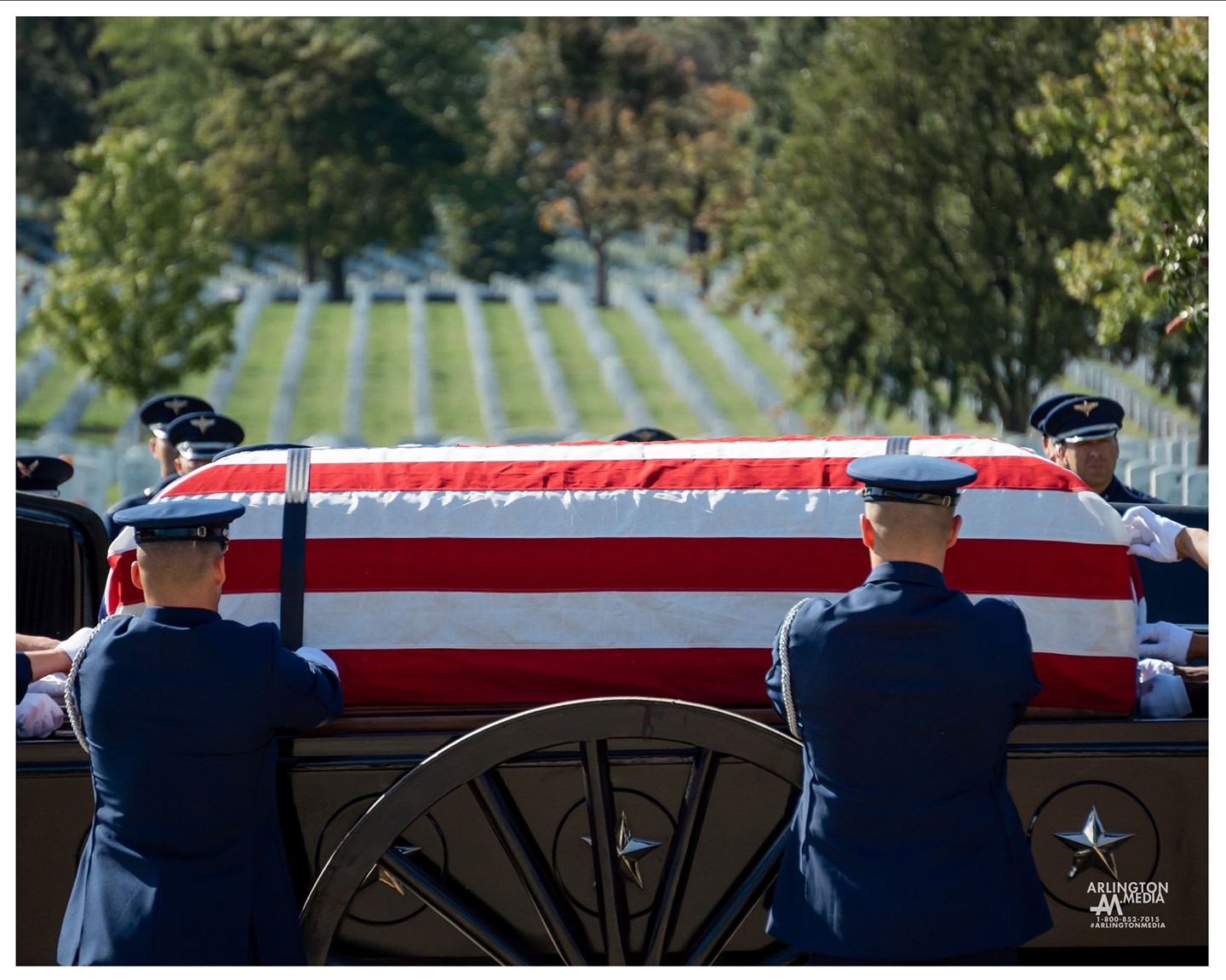 Airmen in the US Air Force carefully drape a flag over a casket on the caisson at Arlington National Cemetery.

These soldiers are preparing this casket for its final ride through the hallowed grounds of Arlington National Cemetery.  They do so with the utmost honor, dignity, and respect.