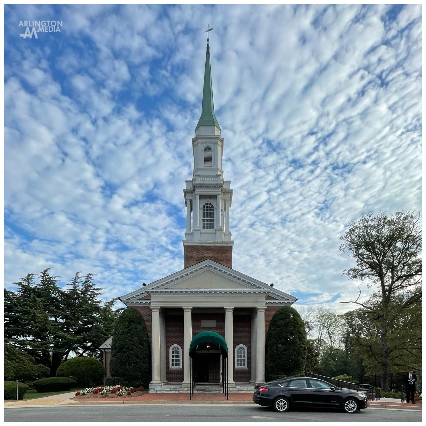 The Old Post Chapel at Fort Myer before a service at Arlington National Cemetery as captured by our @arlingtonmedia team.

“The Quartermaster Corps of the Army designed and constructed this chapel at Fort Myer and also built the new entrance gateway to the National Cemetery, completed in 1935.  The chapel is used for religious services at the post and also for rites in the cemetery. It is a brick building with wood cornice, an entrance porch of four stone columns, and a wood spire which rises to a height of 97 feet.

A 1998 Technical Report by the US Army Corps of Engineers notes that this construction project was part of a host of “New Deal programs [that]…resulted in a construction boom on Army installations. Installations increased in size as training areas expanded. 

The Historic Fort Myer website explains that “over time,…this one building would become the iconic representation when one thought about Fort Myer. It was the focal point proudly occupying the center of the garrison’s insignia. In addition to providing a place for worship for the Fort Myer Military community, it hosted many weddings and also provided the starting place for many of the final honors which would end in adjacent Arlington National Cemetery."

Today, this Old Post Chapel is still a site for worship, weddings, and many funerals that honor fallen veterans being buried at Arlington National Cemetery.