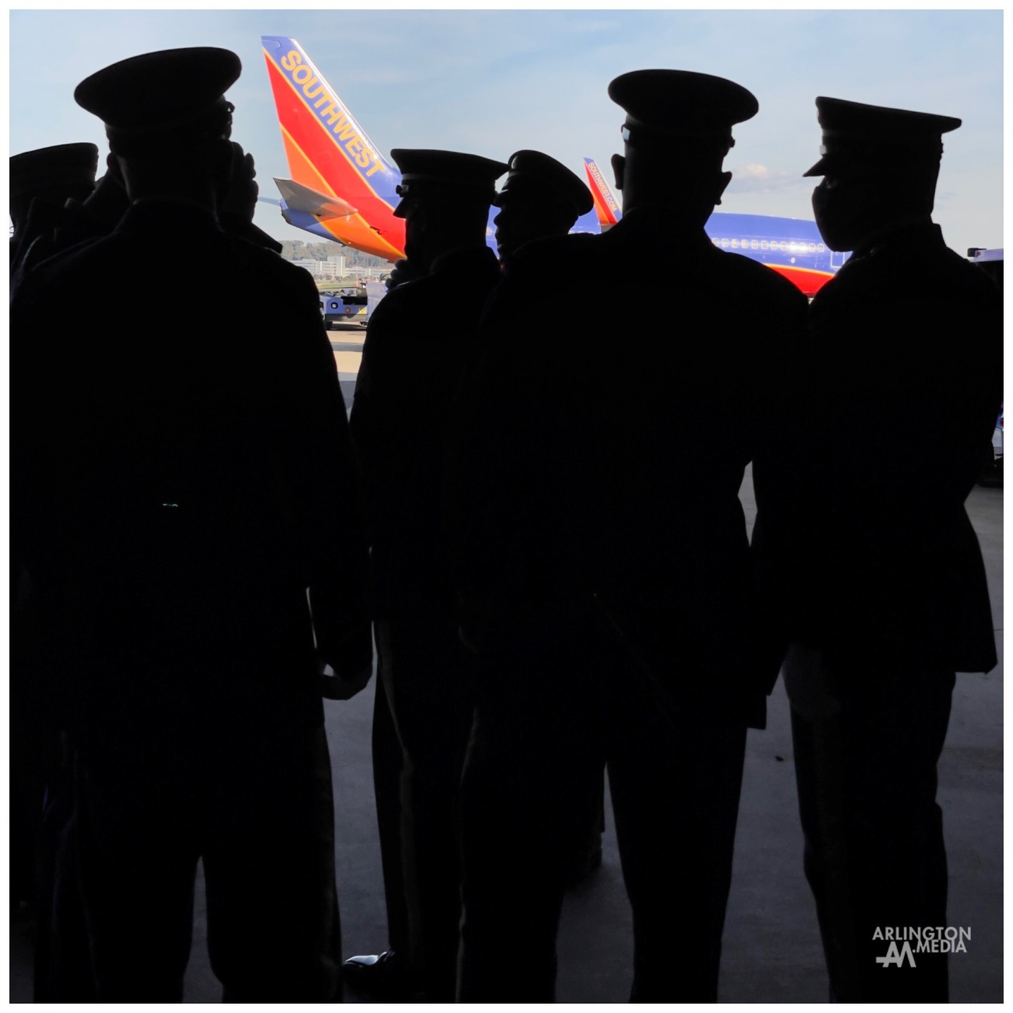 Members of Hotel Company of the US Army Old Guard await the dignified arrival of veteran remains on the Tarmac this past Friday.

While everyone is looking out at the aircraft turning into the bay, the soldiers standing in salute, police cars flashing their red, white, and blue display, and sometimes even crossed streams of water from fire trucks at the ready, one of the most compelling parts of these experiences, is turning the opposite direction, looking back, and seeing the many faces pressed against the glass in reverence. 

Capturing moments like this on site is not new for our @arlingtonmedia team, but we are always honored to have the opportunity to do so for a military family.  Thank you.
@southwestair 
@reagan_airport 
@usarmyoldguard