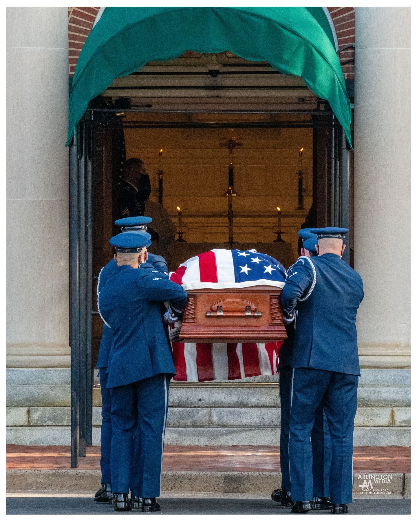 US Air Force airmen carry the remains of an honored veteran into the Old Post Chapel before a service at Arlington National Cemetery in Arlington, Virginia.