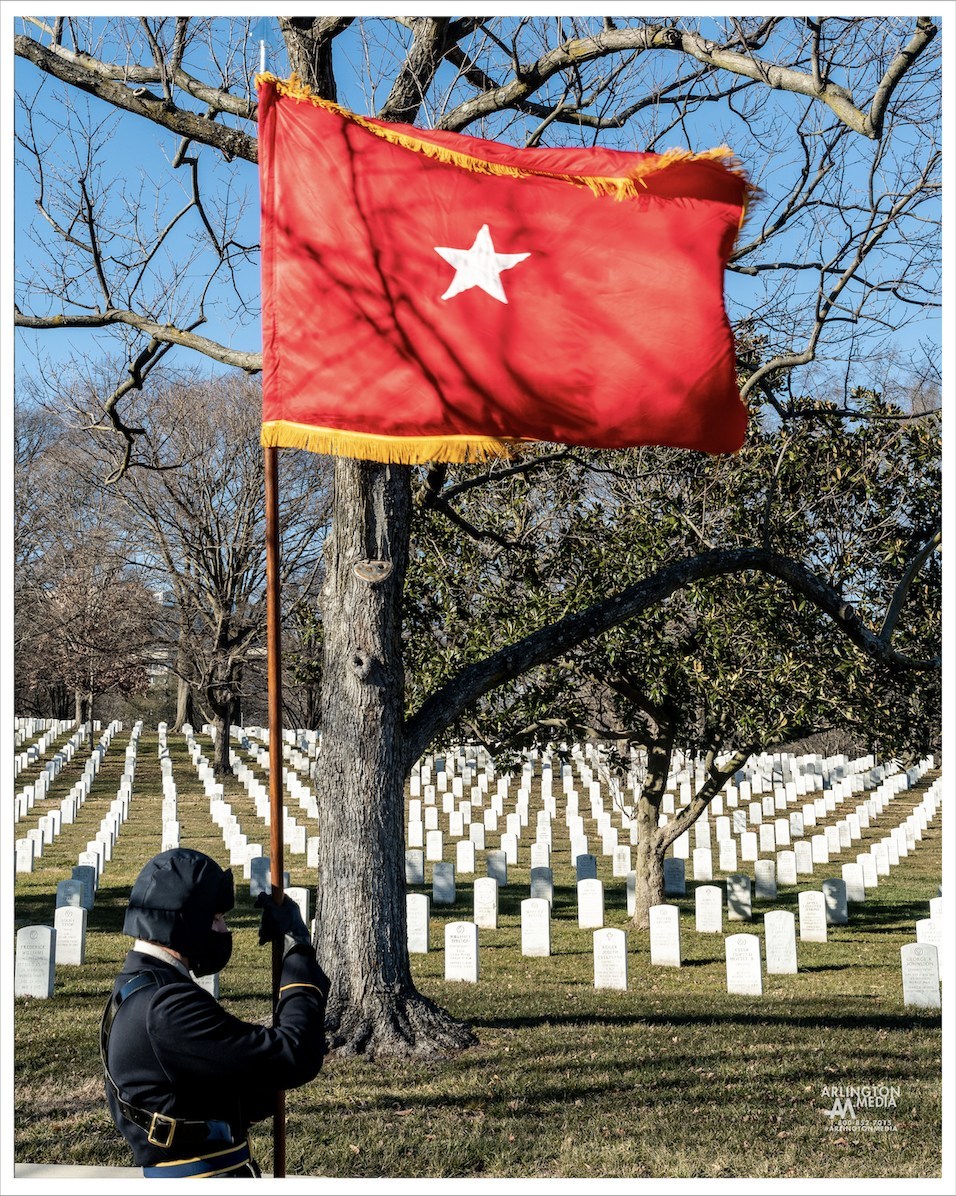 Pictured here is a flag unfurled at a service in Arlington National Cemetery.  This flag honors a one star general officer during a full honors service in Arlington.

Several hallmarks of services for General Officers include a caparisoned horse, a red flag with the number of stars awarded that General Officer, and a battery cannon salute.

Army and Marine Corps colonels and General Officers may be provided a caparisoned (riderless) horse, if available. 

Army General Officers may receive a battery cannon salute (17 guns for a four-star general, 15 for a three-star, 13 for a two-star, 11 for a one-star), if available. 

Minute guns may be used for General Officers/Flag Officers of the Coast Guard, Marine Corps and Navy, if available. The President of the United States is entitled to a 21-gun salute, while other high state officials receive 19 guns.
