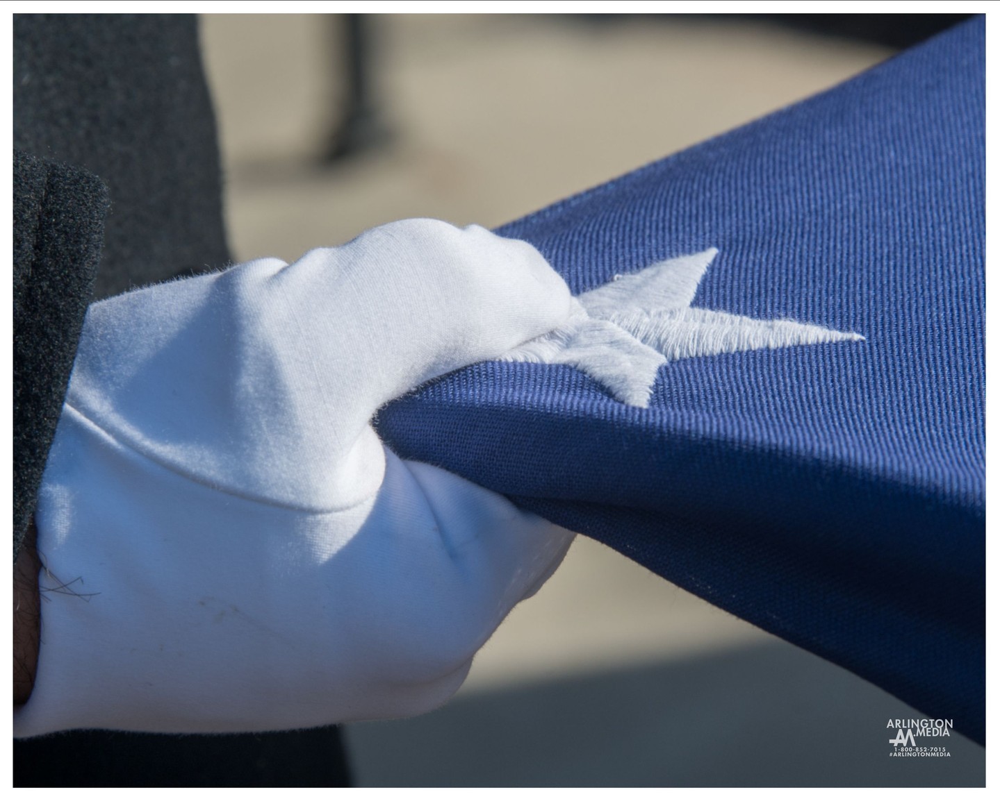 A soldier meticulously holds the flag during a service capture by the @arlingtonmedia team in Arlington National Cemetery.